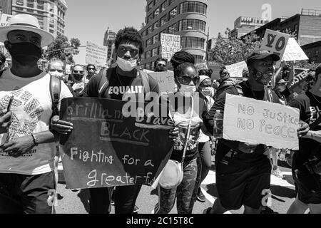 Manhattan, New York, USA - June 6, 2020: Young men and women marching in a Black Lives matter protest to the Killing of George Floyd by a policeman. Stock Photo