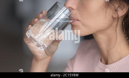 Close up profile thirsty woman drinking pure mineral water Stock Photo