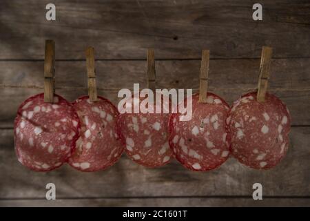 Slices of salami hanging Stock Photo