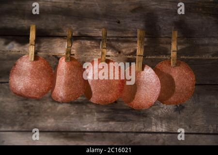 Slices of salami hanging Stock Photo