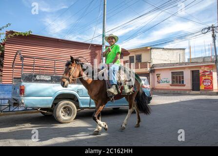 Lake Atitlan, Guatemala, 1st March 2020: mayan man traveling on a horse in streets Stock Photo