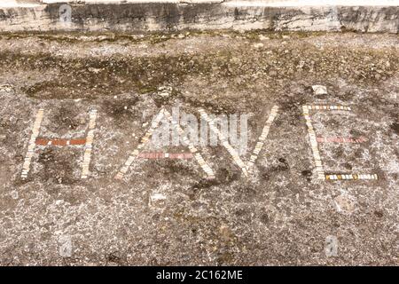 The 'HAVE' Mosaic (spelling variant of the Latin word Ave - 'hail') in the House of the Faun (Casa del Fauno), ancient city of Pompeii, Italy Stock Photo