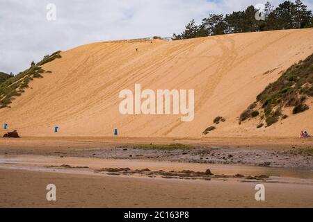 São Martinho do Porto Beach, Portugal - Natural Mediterranean Bay with Golden Sand, Tranquil Ocean Water with  Unique Rock Formations and a Big Dune Stock Photo