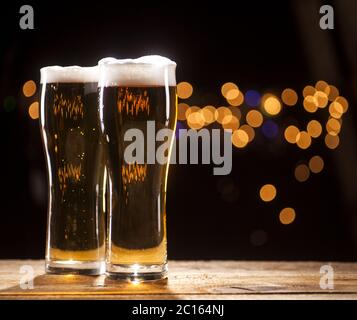 Two glasses of beer on bar lights background Stock Photo