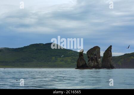 Three Brothers Rocks in the Avacha Bay of Pacific Ocean. Coast of Kamchatka. Stock Photo