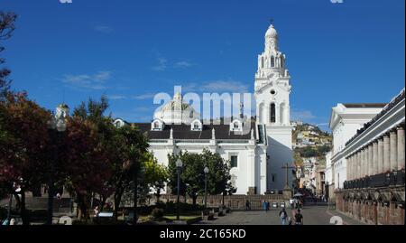 Quito, Pichincha / Ecuador - September 16 2018: People walking near the Metropolitan Cathedral of Quito with the Virgin of El Panecillo in the backgro Stock Photo
