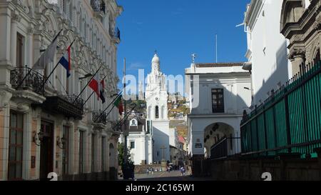 Quito, Pichincha / Ecuador - September 16 2018: People walking near the Metropolitan Cathedral of Quito with the Virgin of El Panecillo in the backgro Stock Photo