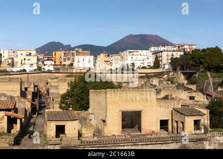 An aerial view across the Roman ruins and excavations of the ancient town of Herculaneum (Ercolano) with Mount Vesuvius volcano, Campania, Italy Stock Photo