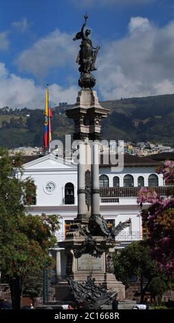 Quito, Pichincha / Ecuador - September 16 2018: View of the independence monument located in the big square with the Carondelet palace in the backgrou Stock Photo
