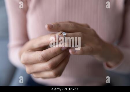 Close up woman taking off wedding ring, divorce concept Stock Photo