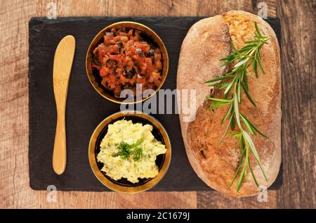 Bread, bruschetta and herbs butter on the table. Stock Photo