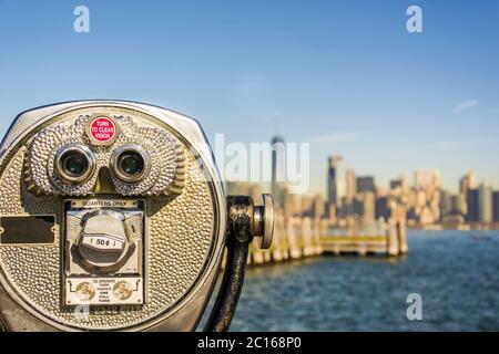 Close up of tower viewer binoculars with blurred New York City skyline Stock Photo
