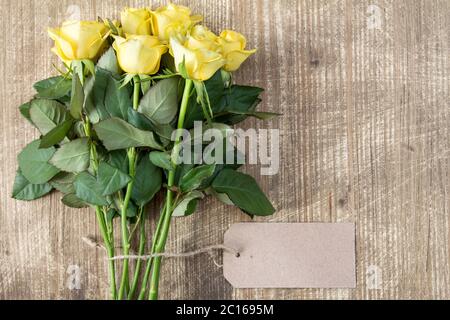 Bunch of yellow roses with blank tag tied with string Stock Photo - Alamy