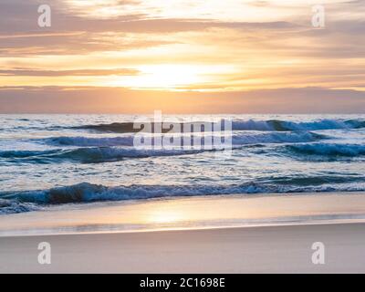 sand with sea wave hit the beach , cloudy sky at sunset time Stock Photo