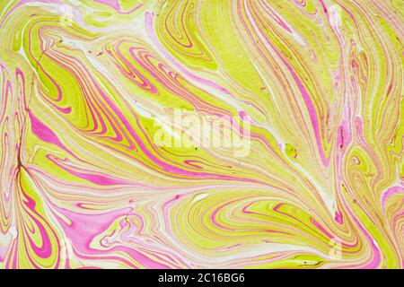 Delicate abstract marbleized pattern with fine swirling lines of pink on yellow and white in a full frame view for wallpaper or print Stock Photo