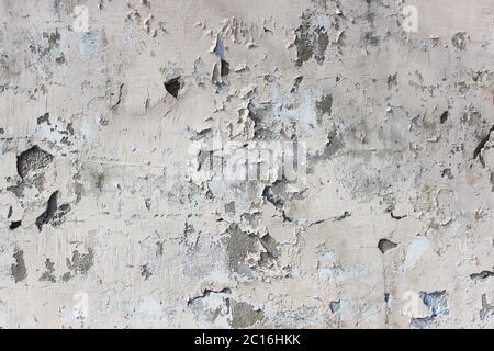 old beige wall with peeling plaster for background Stock Photo