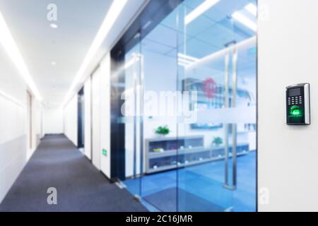 fingerprint scanner on wall in modern corridor Stock Photo
