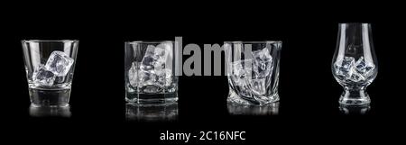 Set of four glasses with cub ice for alcoholic drinks on black background Stock Photo