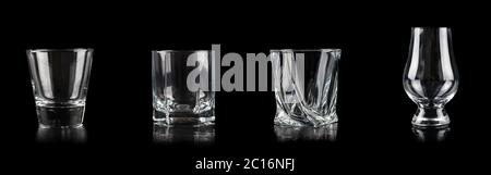 Set of four empty glasses for alcoholic drinks on black background Stock Photo
