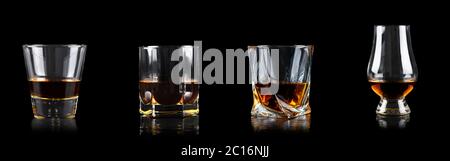 Set of four glass of whiskey or other alcohol on black background Stock Photo