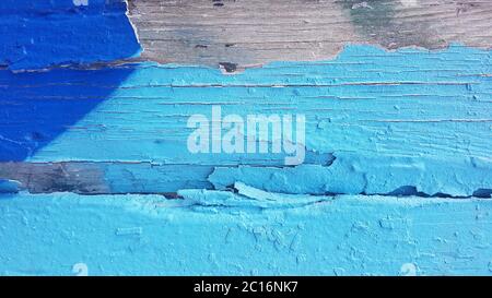 Old weathered paint that separated from old wood and peels off. Stock Photo