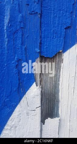 Old weathered paint that separated from old wood and peels off. Stock Photo