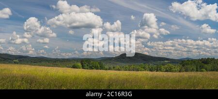 landscape with blue sky and clouds - panorama of rural countryside with field, forest and hills Stock Photo