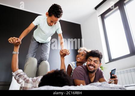 Happy african family enjoying spending time together at home. Stock Photo