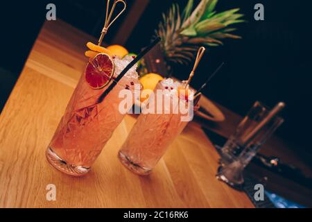 Fresh summer  Author inspired Cocktail Drink - on bar counter on Pineapple fruits Background  . Close-up Top view . Copy paste space for design people Stock Photo