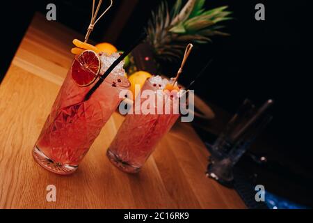 Fresh summer  Author inspired Cocktail Drink - on bar counter on Pineapple fruits Background  . Close-up Top view . Copy paste space for design people Stock Photo