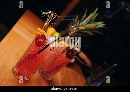 Fresh summer  Author inspired Cocktail Drink - on bar counter on Pineapple fruits Background  . Close-up Top view . Copy paste space for design people Stock Photo