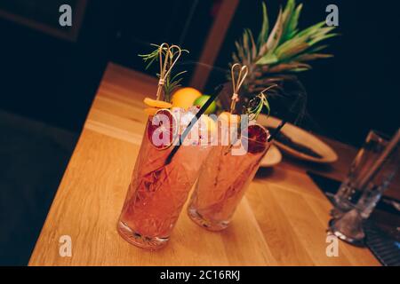 Fresh summer  Author inspired Cocktail Drink - on bar counter on Pineapple fruits Background  . Close-up Top view . Copy paste space for design people Stock Photo