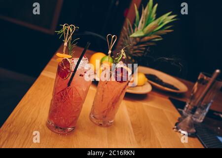 Fresh summer  Author inspired Cocktail Drink - on bar counter on Pineapple fruits Background  . Close-up Top view . Copy paste space for design people Stock Photo