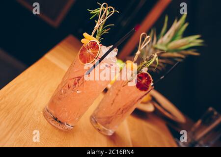 Fresh summer  Author inspired Cocktail Drink - on bar counter on Pineapple fruits Background  . Close-up Top view . Copy paste space for design people Stock Photo