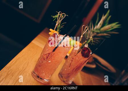 Fresh summer  Author inspired Cocktail Drink - on bar counter on Pineapple fruits Background  . Close-up Top view . Copy paste space for design people Stock Photo