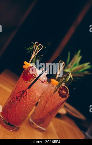 Fresh summer  Author inspired Cocktail Drink - on bar counter on Pineapple fruits Background  . Close-up Top view . Copy paste space for design people Stock Photo