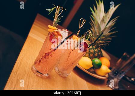 Fresh summer  Author inspired Cocktail Drink - on bar counter on Pineapple fruits Background  . Close-up Top view . Copy paste space for design people Stock Photo