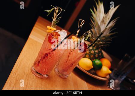 Fresh summer  Author inspired Cocktail Drink - on bar counter on Pineapple fruits Background  . Close-up Top view . Copy paste space for design people Stock Photo