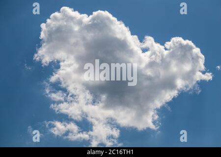 single white cloud in the blue sky on a sunny day Stock Photo