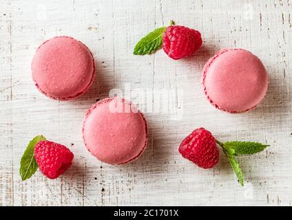 pink macaroons on white wooden table, top view Stock Photo