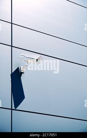 CCTV camera on an office building wall. Stock Photo