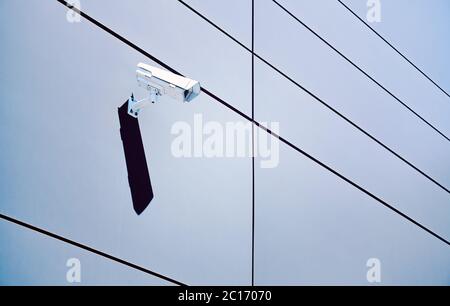 CCTV camera on an office building wall, color toning applied. Stock Photo