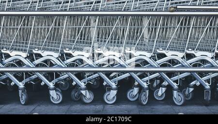 Row of empty shopping carts, color toning applied. Stock Photo
