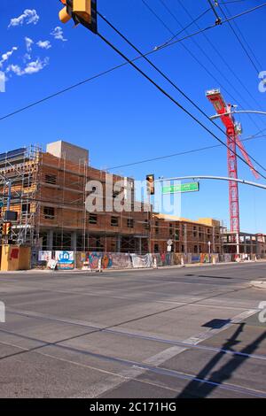 New construction continues in Tucson AZ. Here on the corner of 4th Ave and 6th work is underway on a multi-space project after covid19 Stock Photo
