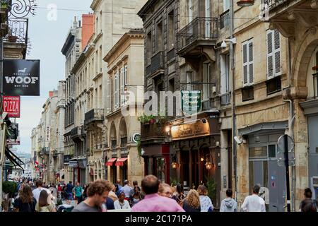 A view along Rue Saint-Remi a commercial street in the centre of Bordeaux city with pedestrians, shops, bars and restaurants Stock Photo