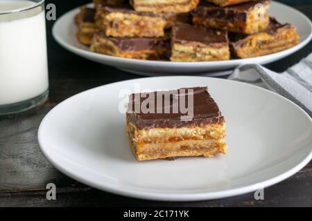Hungarian Zserbo Szelet (Gerbaud Cake): A traditional Hungarian dessert made of layers of pastry, apricot jam, walnuts, and dark chocolate Stock Photo