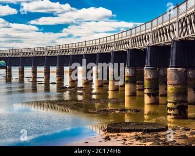 The Tay Rail Bridge at low tide from Dundee, Scotland, United Kingdom. The remains of piers of the earlier bridge are visible. Stock Photo