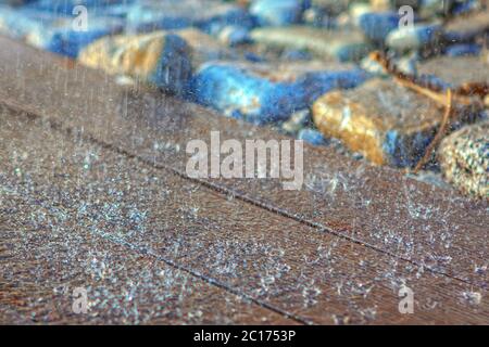 raindrops on a wooden surface , floor of  exterior shower with water drops Stock Photo
