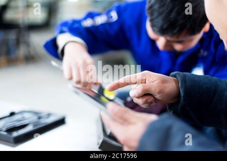 young worker working in factory Stock Photo