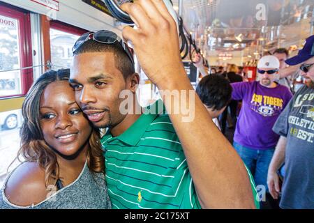 New Orleans Louisiana,Regional Transit Authority,RTA,Riverfront Streetcar Line,tram,trolley,Black man men male,woman female women,couple,hugging,passe Stock Photo